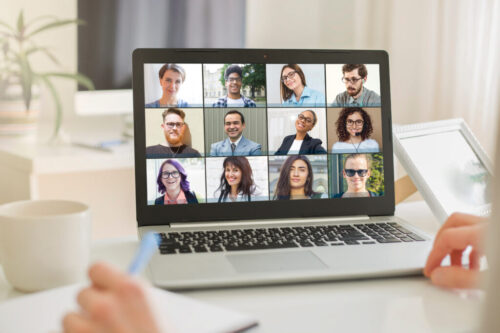 Online conference of colleagues through a laptop monitor. Video call for training. Educational webinar chat between different people.